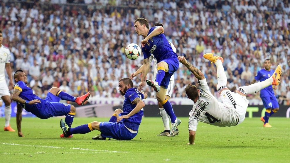 Real Madrid's defender Sergio Ramos (R) kicks the ball past Juventus' defender Leonardo Bonucci (2ndL), Juventus' Swiss defender Stephan Lichtsteiner (2ndR) and Juventus' Chilean midfielder Arturo Vidal during the UEFA Champions League semi-final second leg football match Real Madrid FC vs Juventus at the Santiago Bernabeu stadium in Madrid on May 13, 2015. AFP PHOTO/ GERARD JULIEN        (Photo credit should read GERARD JULIEN/AFP/Getty Images)