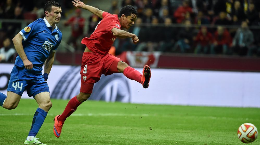 Carlos Bacca of Sevilla FC shoots to score his side's third goal during the UEFA Europa League final against FC Dnipro Dnipropetrovsk
