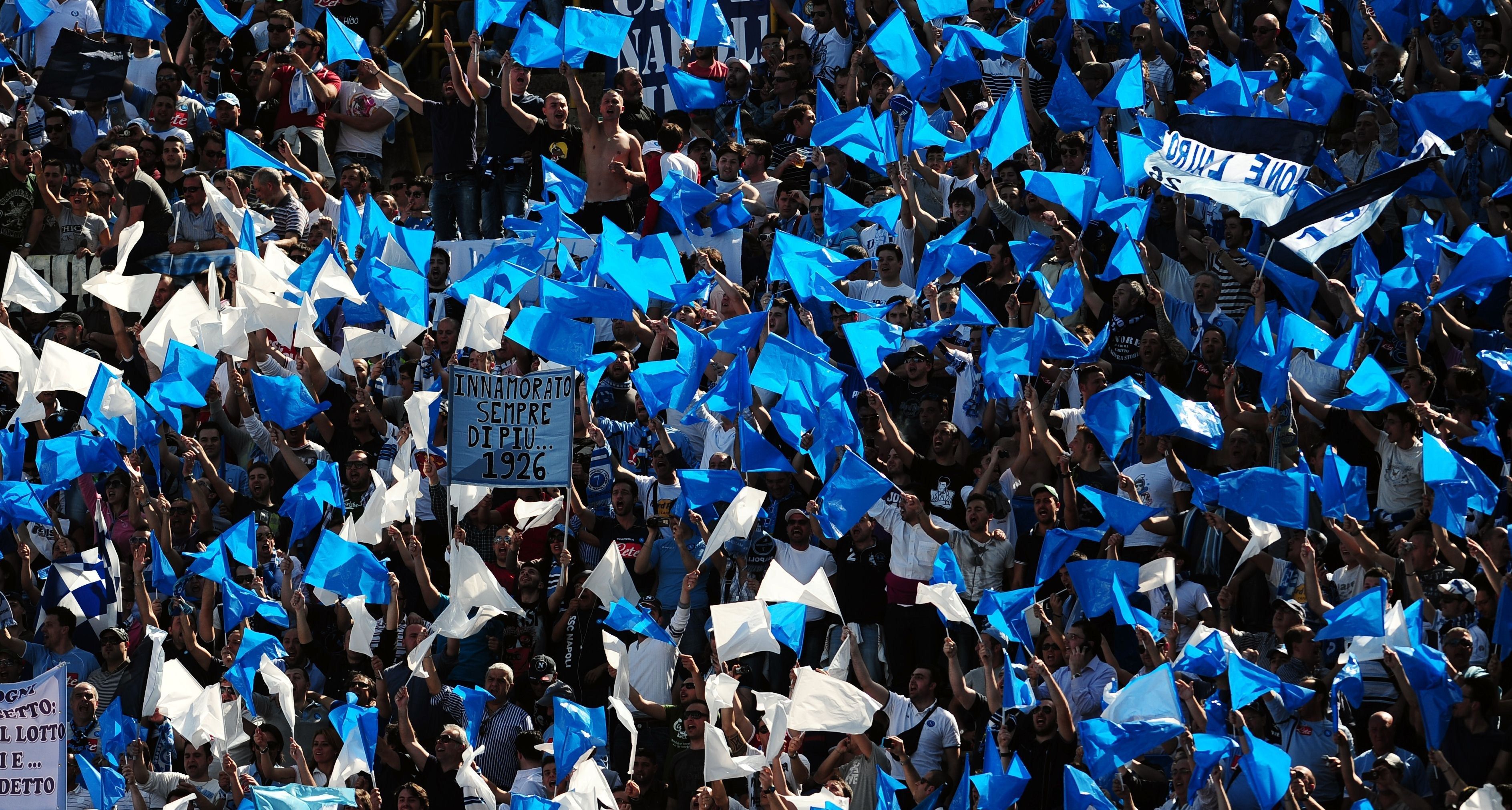 SSC Napoli's supporters cheer their team during their Serie A football match against FC Bologna at Dall'Ara stadium in Bologna on April 10, 2011. AFP PHOTO / TIZIANA FABI (Photo credit should read TIZIANA FABI/AFP/Getty Images)