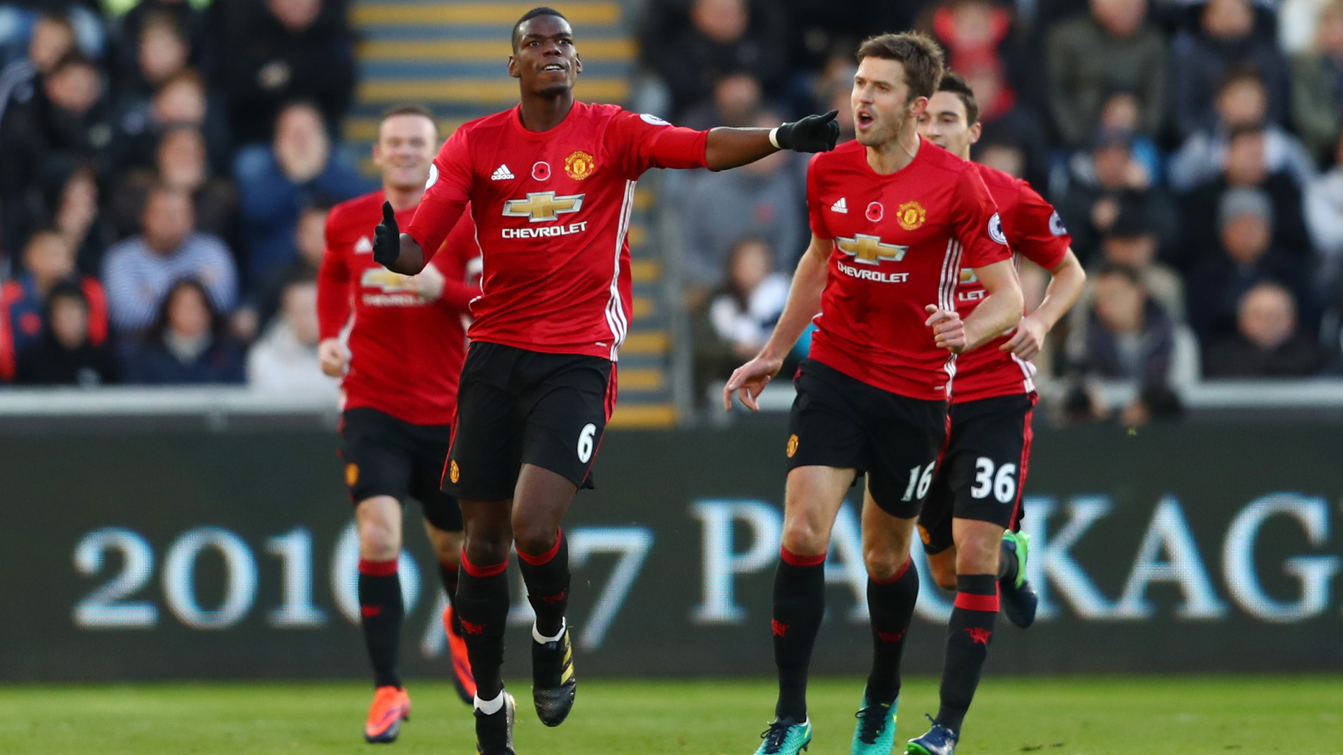 SWANSEA, WALES - NOVEMBER 06: Paul Pogba of Manchester United celebrates scoring his sides first goal with Michael Carrick during the Premier League match between Swansea City and Manchester United at Liberty Stadium on November 6, 2016 in Swansea, Wales.  (Photo by Michael Steele/Getty Images)