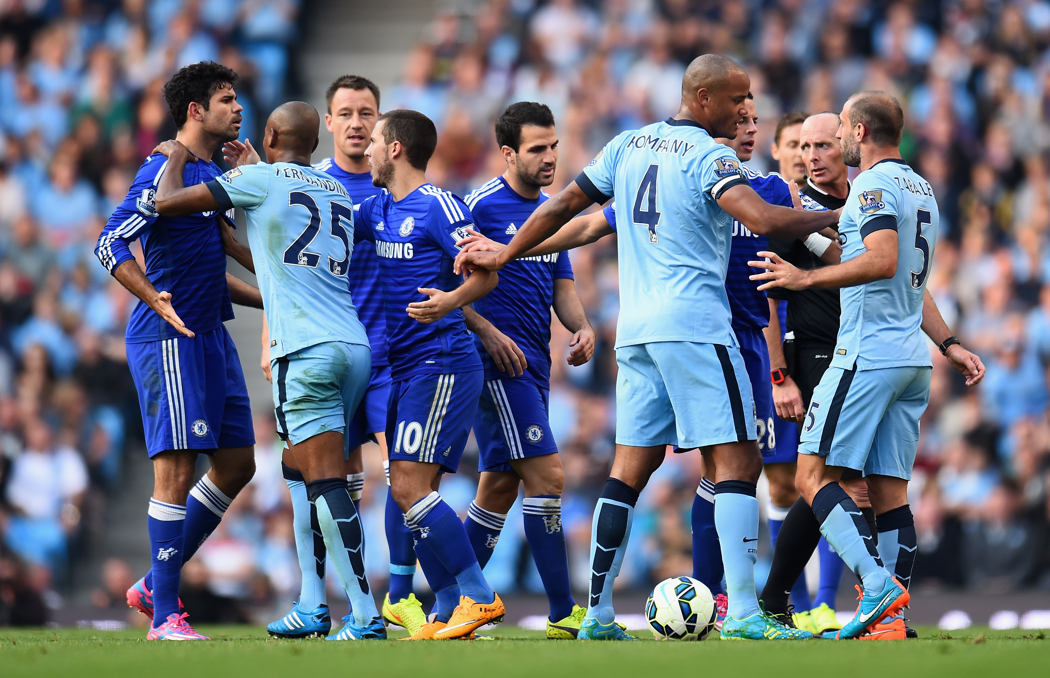 MANCHESTER, ENGLAND - SEPTEMBER 21:   Pablo Zabaleta of Manchester City is separated from Diego Costa of Chelsea by his team-mates during the Barclays Premier League match between Manchester City and Chelsea at the Etihad Stadium on September 21, 2014 in Manchester, England.  (Photo by Shaun Botterill/Getty Images)